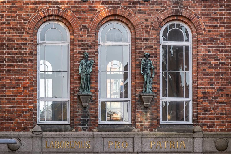 Facade of a brick building with Latin inscription and sculptures between windows, elephant tower, by architect Vilhelm Dahlerup, Carlsberg district, Copenhagen, Denmark, Europe