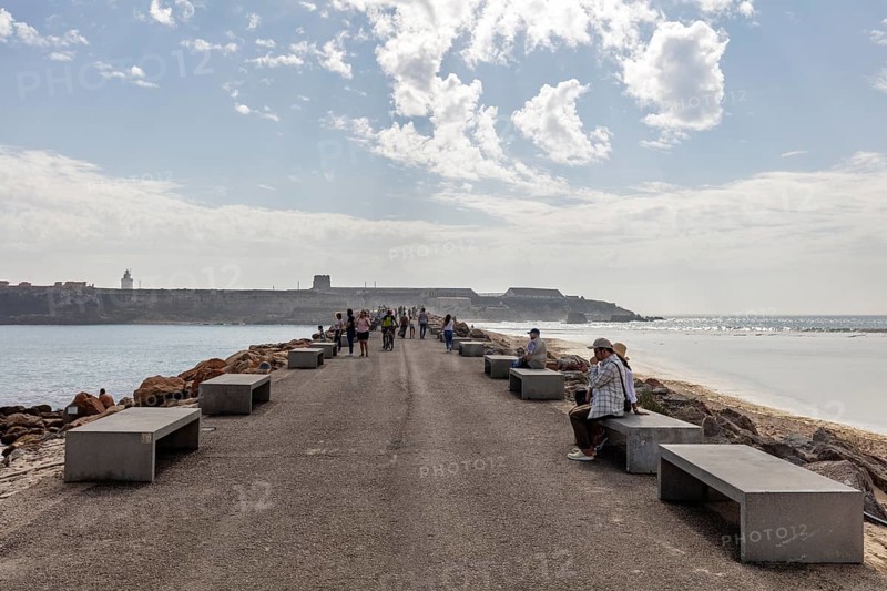 Promenade with benches and people enjoying the view of the sea, Tarifa