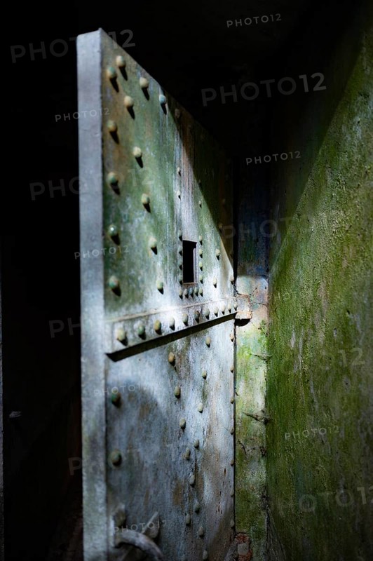 Bunker door from outside, Bunker Cheneux, dark, rays of light, 2nd World War, built 1933-1936, Ardennes Offensive, walls on the right green and weathered, Cheneux, Ardennes, Belgium, Europe