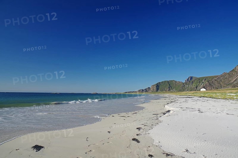 Beautiful beach with clear blue sky, gentle waves and mountains in the background, Bleik, Vesteralen, Langoya, Nordland, Norway, Europe