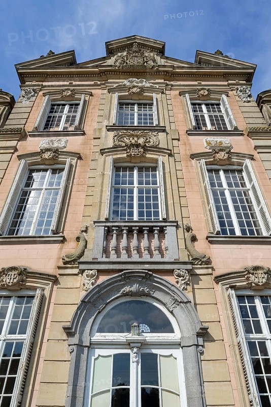 Façade with high relief architectural ornaments above windows of 1750 Poeke Castle, Kasteel van Poeke in Rococo style, Aalter, East Flanders, Belgium, Europe