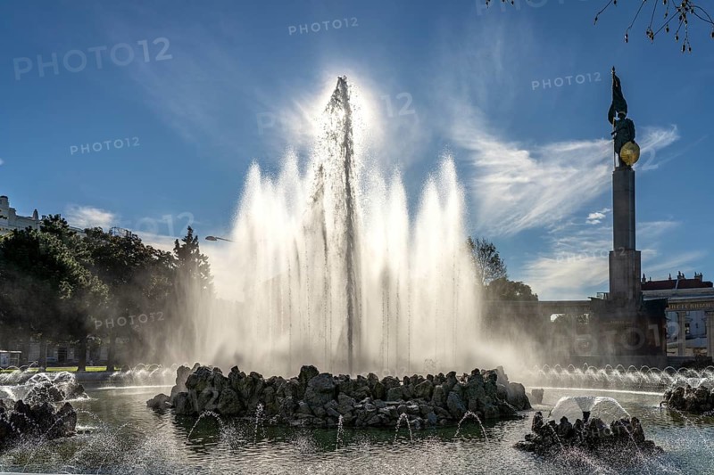The high-jet fountain and the memorial in honour of the soldiers of the Soviet Army on Schwarzenbergplatz in Vienna, Austria, Europe