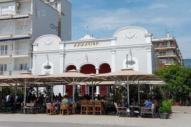 A white building with restaurant and terrace where people sit in sunny weather, cinema, Achilleion, Argonafton street, Volos, Pagasitic Gulf, Thessaly region, Greece, Europe