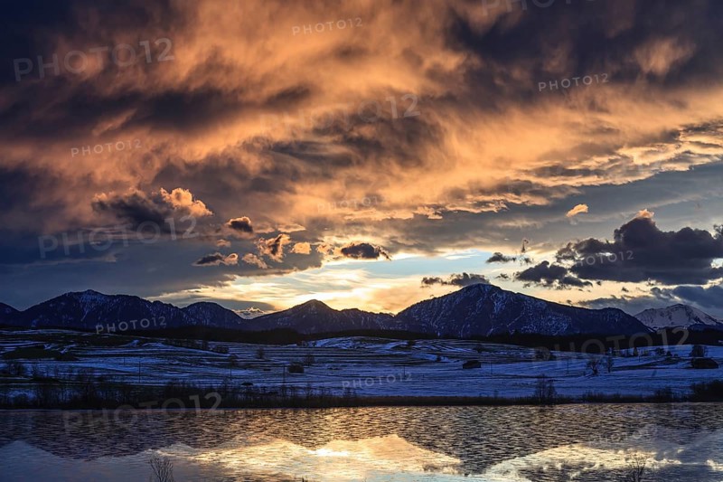 Cloudy mood, morning light, reflection of mountains in lake, icy, snow, winter, Riegsee, view of Jochberg, Alpine foothills, Bavaria, Germany, Europe