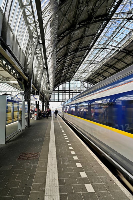Departing train at the central station of the capital, Amsterdam Centraal, Amsterdam, Province of North Holland, Netherlands
