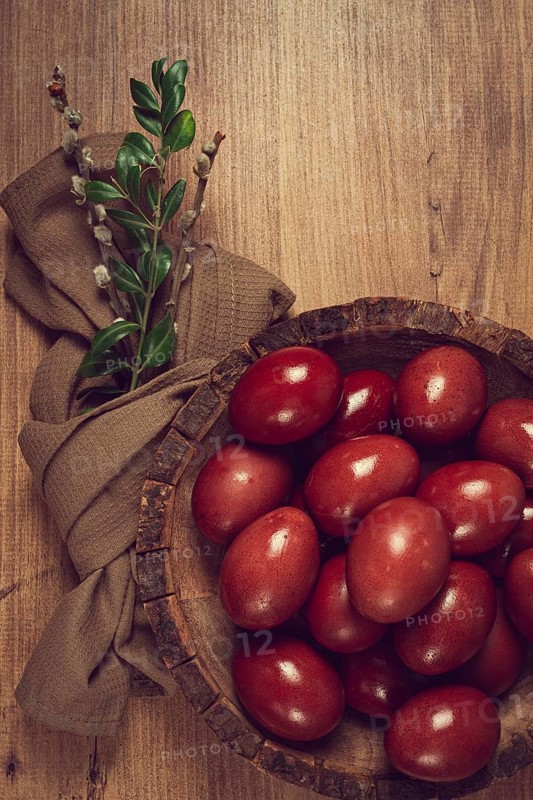 Painted eggs in a wooden bowl, red, painted madder dye, powder from the roots of endro, with onion husks, top view, Easter, Georgia, Asia