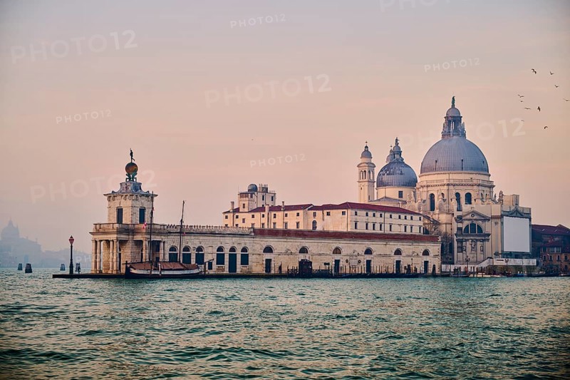 View from 'Colonna di San Marco e San Teodoro' on church 'Basilica di Santa Maria della Salute' on a foggy morning in Venice in winter, Italy, Europe