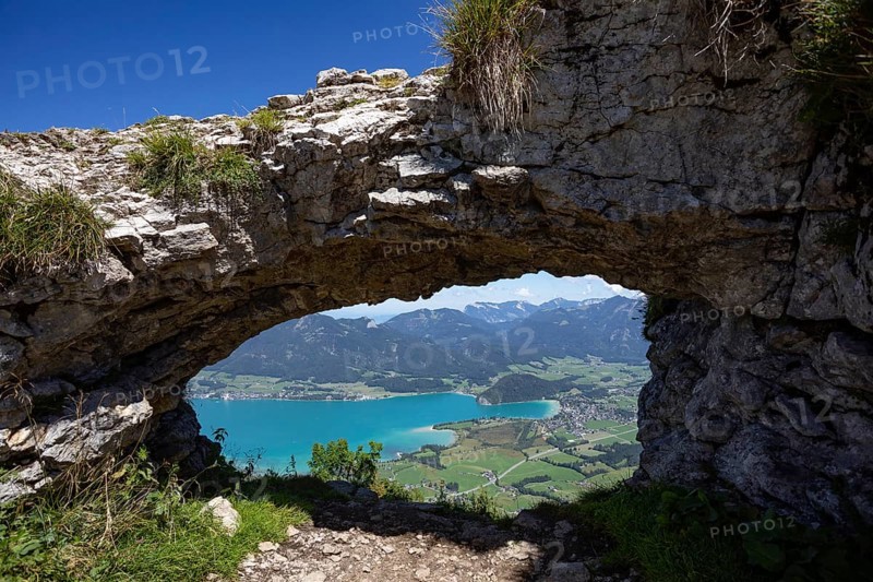 Rock window, view through the Ofenloch on the Bleckwand towards Strobl with Wolfgangsee, Salzkammergut, province of Salzburg, Austria, Europe