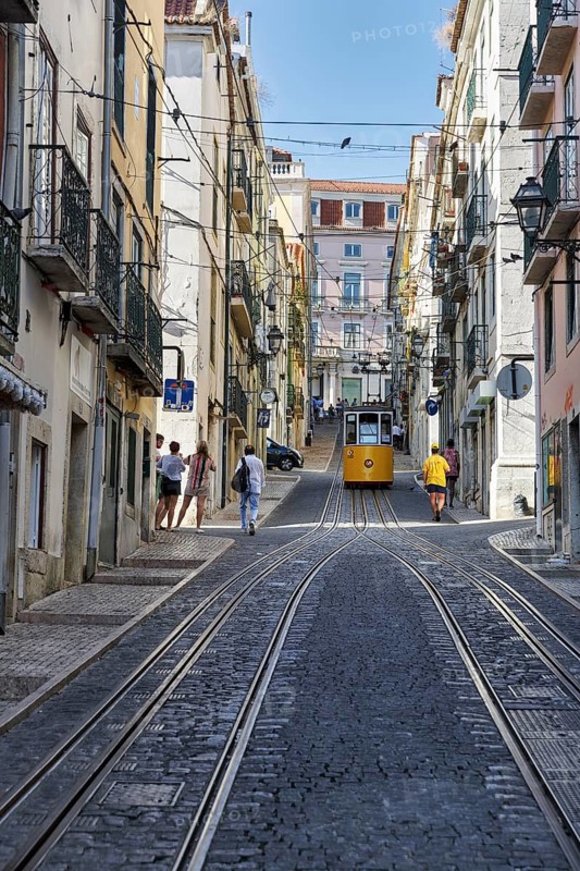 Funicular railway, yellow tram, Elevador da Bica, national monument, old residential buildings, pedestrians in narrow streets, Bairro Alto, Lisbon, Portugal, Europe