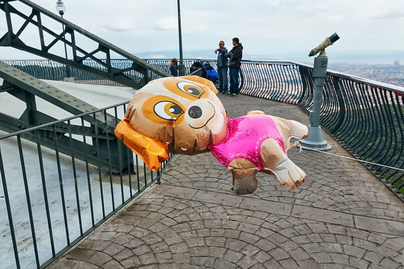 Gas-filled balloon in the shape of a dog, viewing platform, cloudy sky, Tibidabo amusement park, Barcelona, Spain, Europe