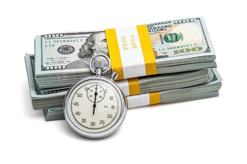 Time is money loan concept background, stopwatch and stack of new 100 US dollars 2013 edition banknotes bills bundles isolated on white