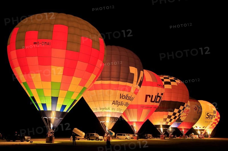 Illuminated hot air balloons at balloon festival at night, Landshut, Bavaria, Germany, Europe