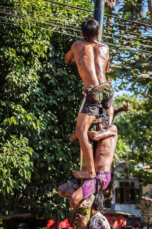 MYANMAR, JANUARY 4, 2014: Greasy pole climbing competition in village on Myanmar independence day