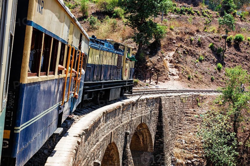 HIMACHAL PRADESH, INDIA, MAY 12, 2010: Toy train of Kalka–Shimla Railway, narrow gauge railway built in 1898 and famous for its scenery and improbable construction. It is UNESCO World Heritage Site