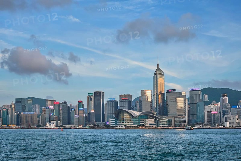 HONG KONG, CHINA, MAY 1, 2018: Hong Kong skyline cityscape downtown skyscrapers over Victoria Harbour in the day time with clouds. Hong Kong, China. Horizontal camera panning