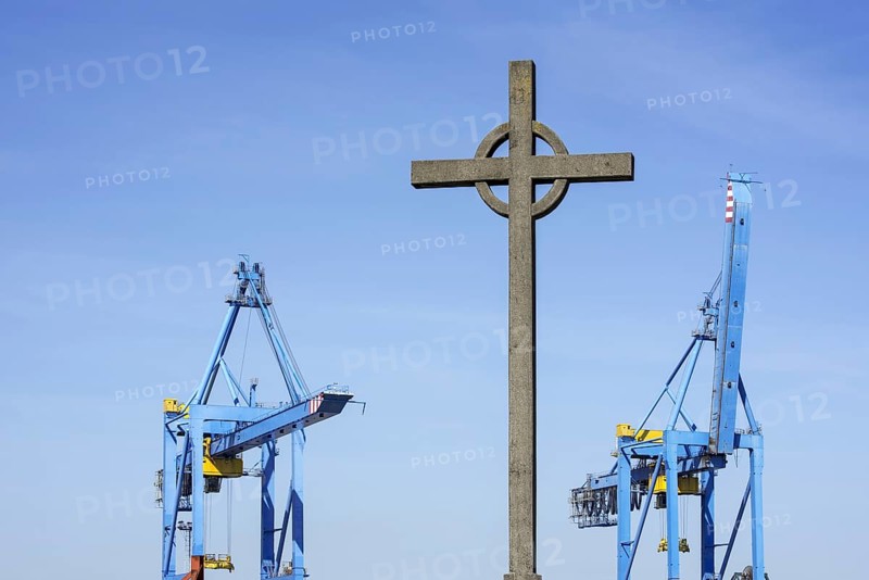 Visserskruis, Fishermen's Cross and container terminal cranes in the seaport of Zeebrugge, West Flanders, Belgium, Europe