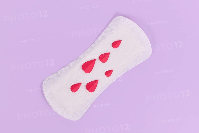 Female period concept with panty liner with symbolic paper blood