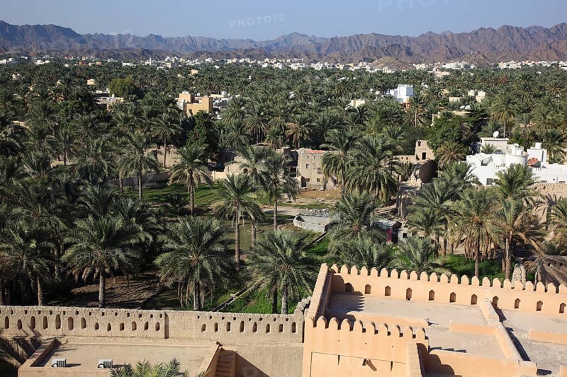 View of the city and the palm gardens of Nizwa from the fort. Nizwa is the centre of the Omani heartland. The oasis town lies on the southern edge of the Hajar Mountains near the Jabal al-Achdar, the highest mountain range in Oman