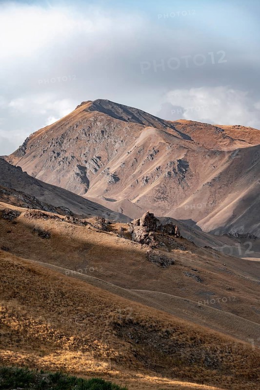 View of mountain landscape with mountain peak at Tyibel Pass, Song Kul Too mountain range, Naryn region, Kyrgyzstan, Asia