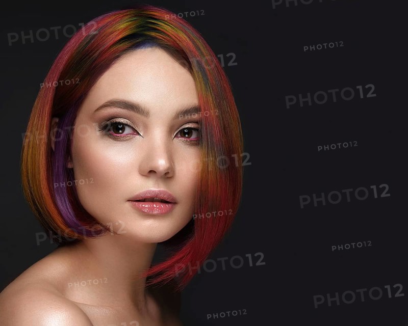 Portrait of beautiful woman with multi-colored hair and creative make up and hairstyle