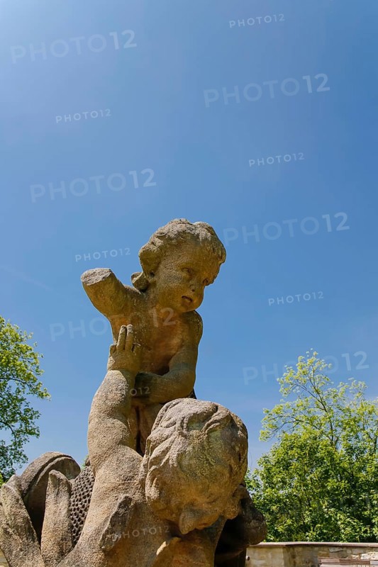 Putti, Putti, group of putti in the castle garden, sculpture, stone sculpture, naked child figure with broken arm, Grafeneck Castle, former hunting lodge of the Dukes of Württemberg around 1560, later summer residence of Duke Carl Eugen von Württemberg, Grafeneck killing centre during the Third Reich, today home for the disabled of the Samaritan Foundation and memorial, documentation centre, historical building, architecture, Gomadingen-Grafeneck, Swabian Alb, Baden-Württemberg, Germany, Europe