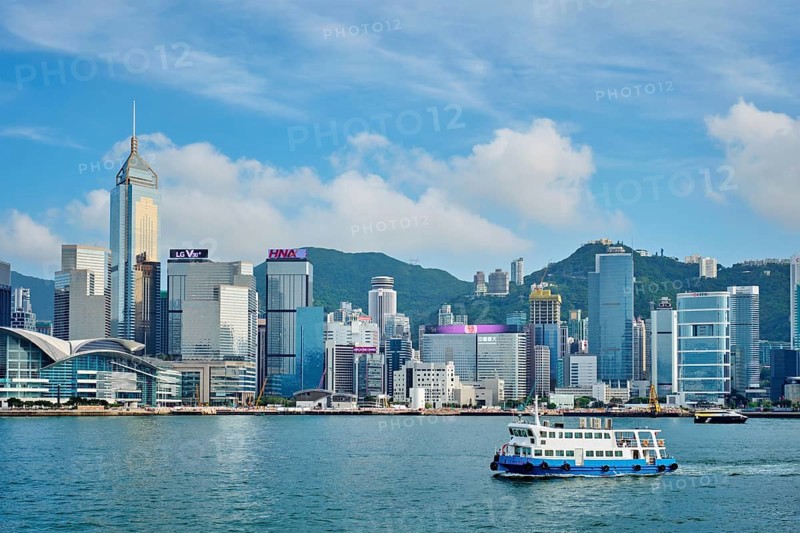 Hong Kong, China, May 1, 2018: Hong Kong skyline cityscape downtown skyscrapers over Victoria Harbour on sunset. Hong Kong, China, Asia