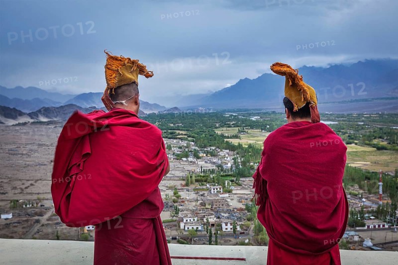 THIKSEY, INDIA, SEPTEMBER 4, 2011: Two Tibetan Buddhist monks blowing conches during morning pooja, Thiksey gompa, Ladakh, India, Asia