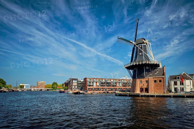 View of Harlem landmark windmill De Adriaan on Spaarne river. Harlem, Netherlands