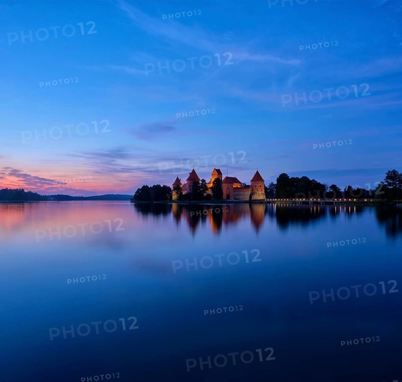 Evening view of Trakai Island Castle in lake Galve illuminated in the night, Lithuania. Square format image