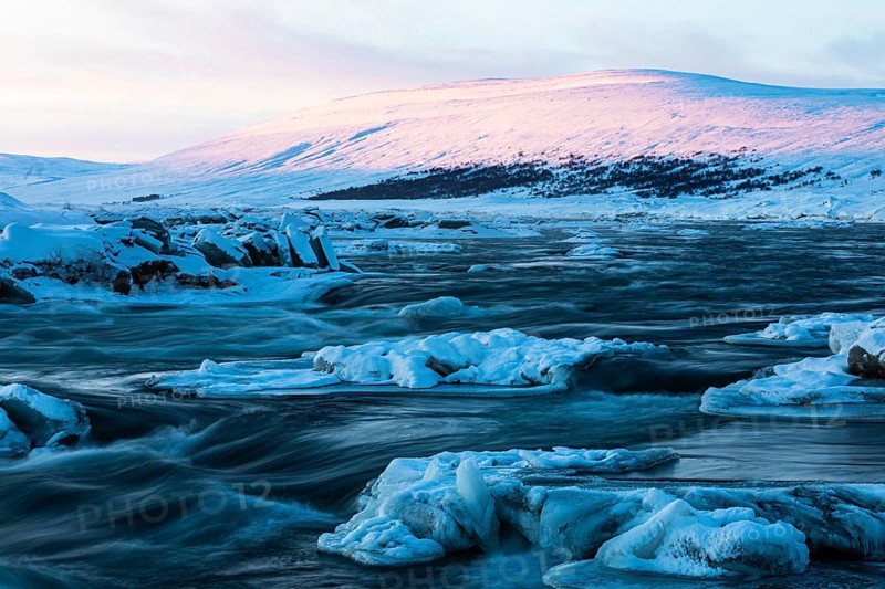 Ice blocks in the river Skalfandafljot at dawn, near the waterfall Godafoss, snow-covered landscape, Northern Iceland Eyestra, Iceland, Europe