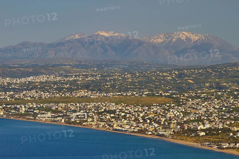 Panorama shot, overview, Dikte massif, snow-capped mountains, sea of houses, blue sea, coast, Heraklion, capital, island of Crete, Greece, Europe