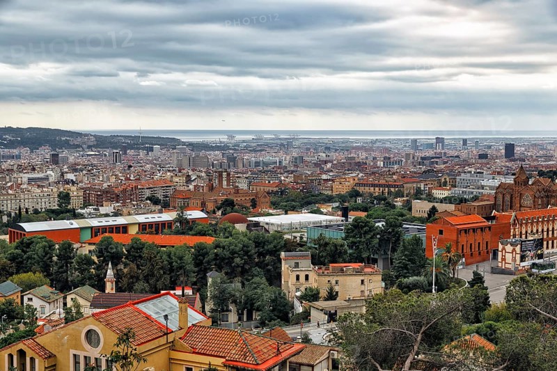View of the sea of houses up to the coast, cloudy sky in autumn, haze, Tibidabo, Barcelona, Spain, Europe