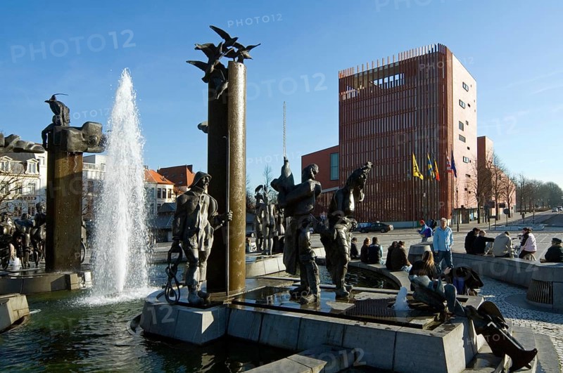 The concert hall and the sculpture group with fountain on Het Zand square in the city of Bruges, West Flanders, Belgium, Europe
