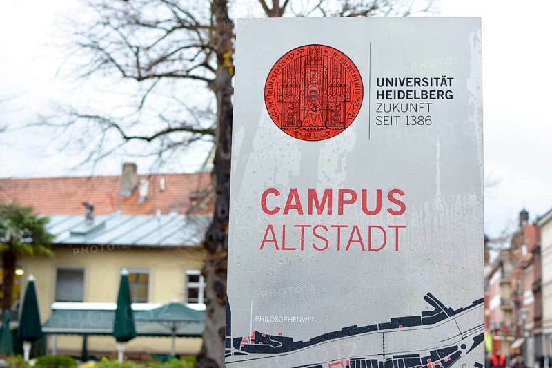 Heidelberg, Germany, March 2019: Informational sign with red university emblem and words University Heidelberg, future since 1386 and Campus historic city center written on it, Europe