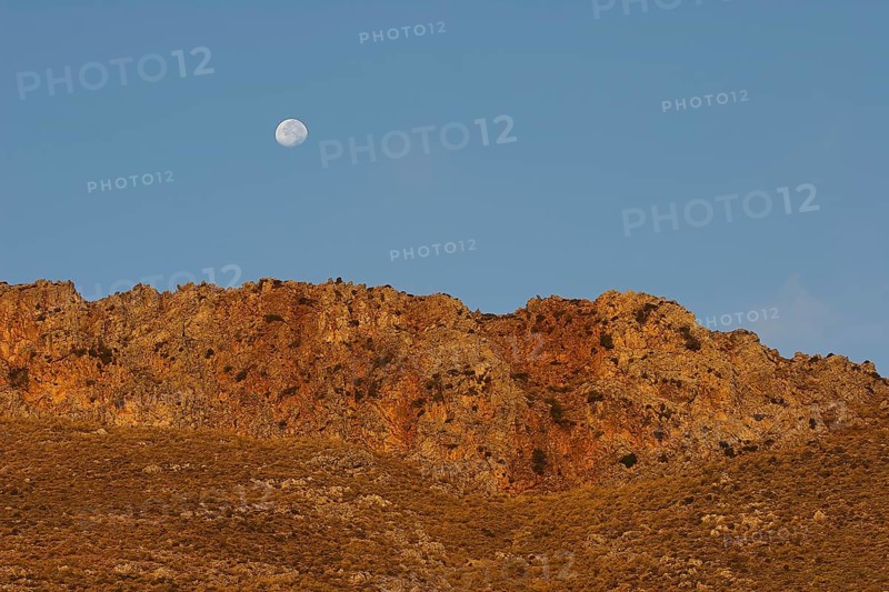 Golden morning light, moon over mountain range, Gramvoussa peninsula, Pirate Bay, Balos, Tigani, blue cloudless sky, West Crete, island of Crete, Greece, Europe