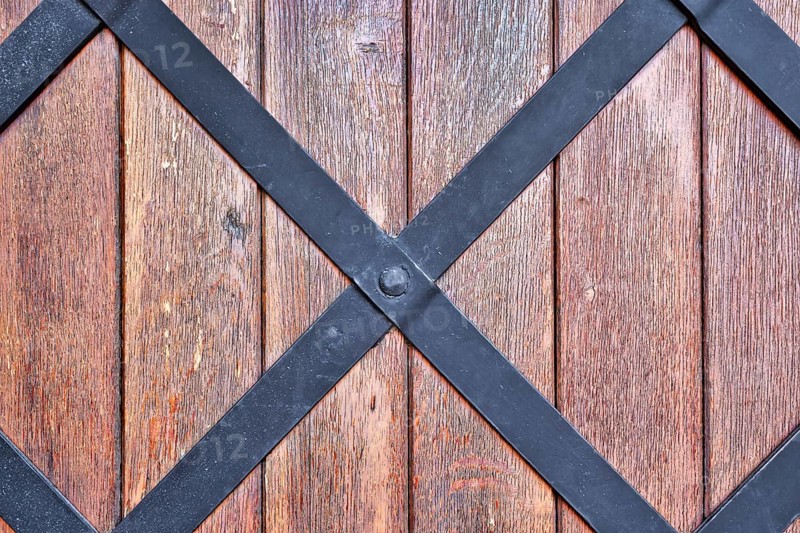 Weathered wood background with iron bars and brown colored planks