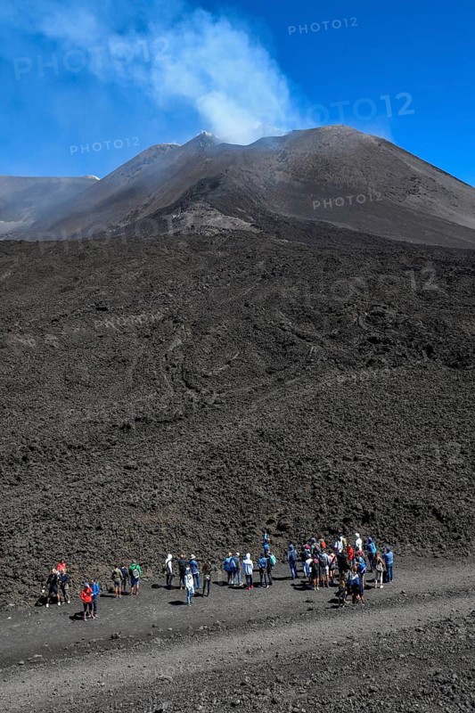 Hikers in the crater landscape of the volcano Etna, summit region, province of Catania, Sicily, Italy, Europe