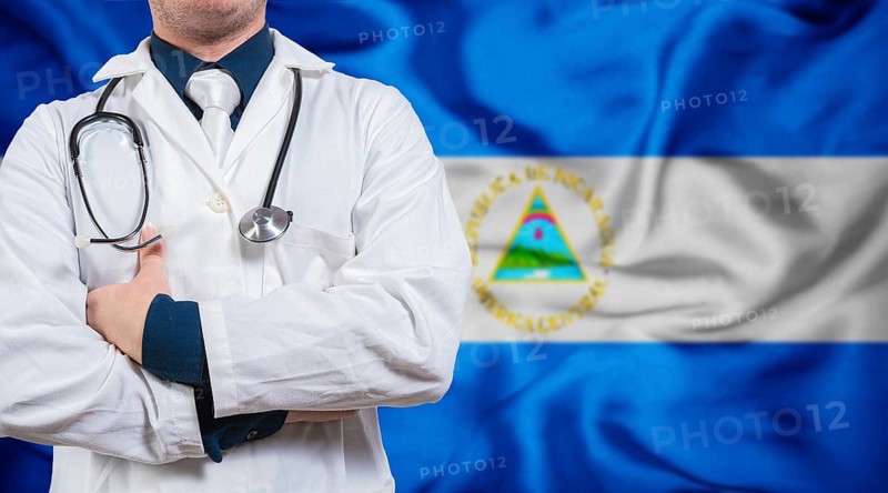 Doctor with stethoscope on flag of Nicaragua. Health and care concept with Nicaragua flag. Doctor with crossed arms on flag of Nicaragua