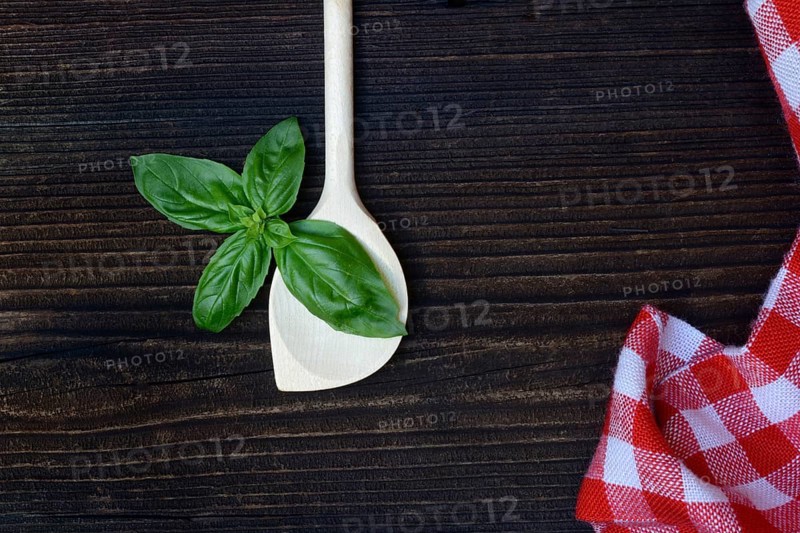 Cooking spoon and basil (Ocimum basilicum)
