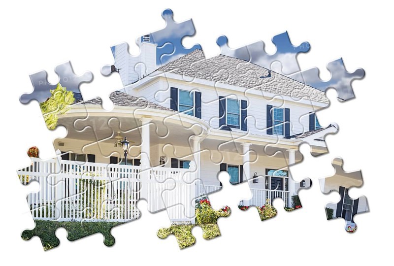New home within puzzle pieces isolated on white