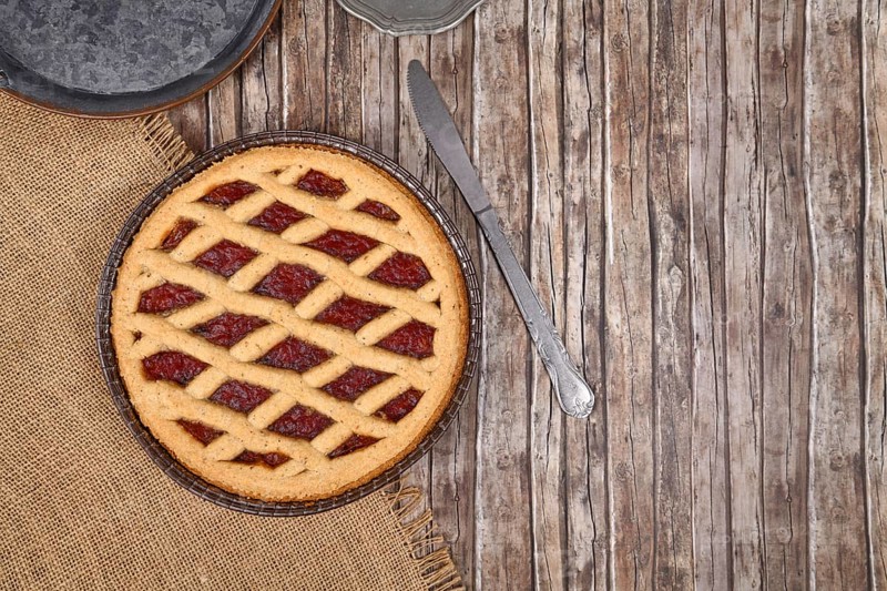 Top view of homemade pie called 'Linzer Torte', a traditional Austrian shortcake pastry topped with fruit preserves and ground nuts with lattice design