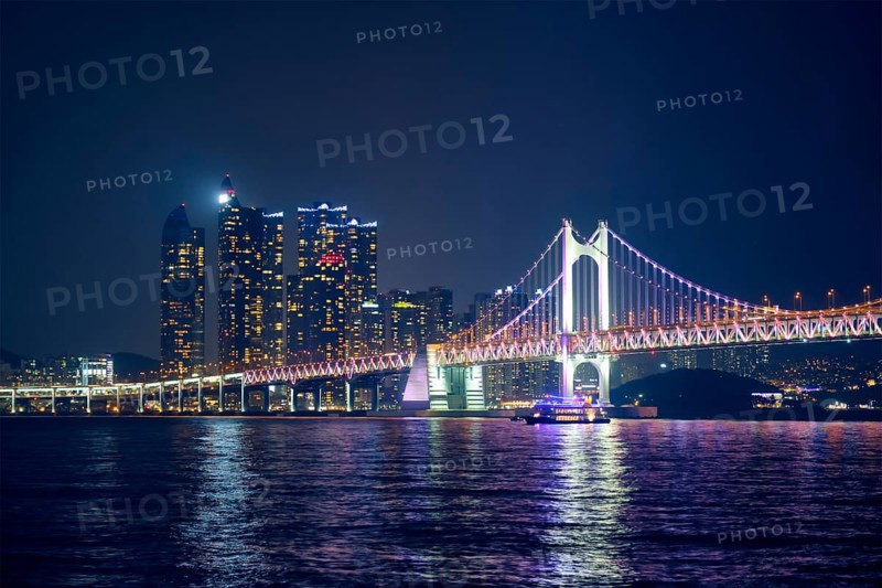 Gwangan Bridge and skyscrapers illuminated in the night. Busan, South Korea, Asia