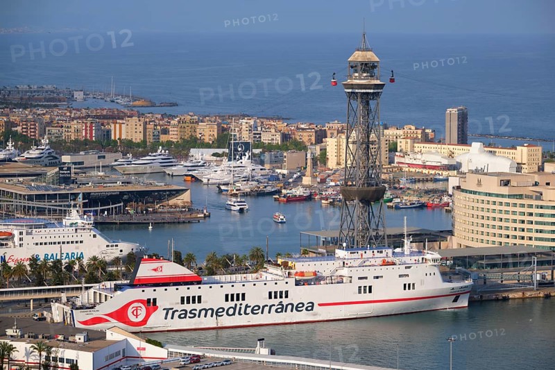 BARCELONA, SPAIN, APRIL 15, 2019: Aerial view of Barcelona city skyline with city traffic and port with yachts and ferry ships and Barcelona's Port Cable Car. Barcelona, Spain, Europe