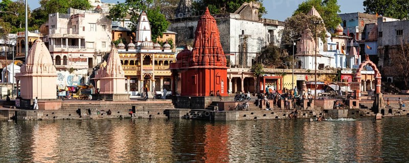 UJJAIN, INDIA, APRIL 24, 2011: People bathing in sacred Rhipra River on ghats of the holy city of Ujjain. There are hundreds of Hindu shrines along the banks of the river Shipra. Stitched panorama