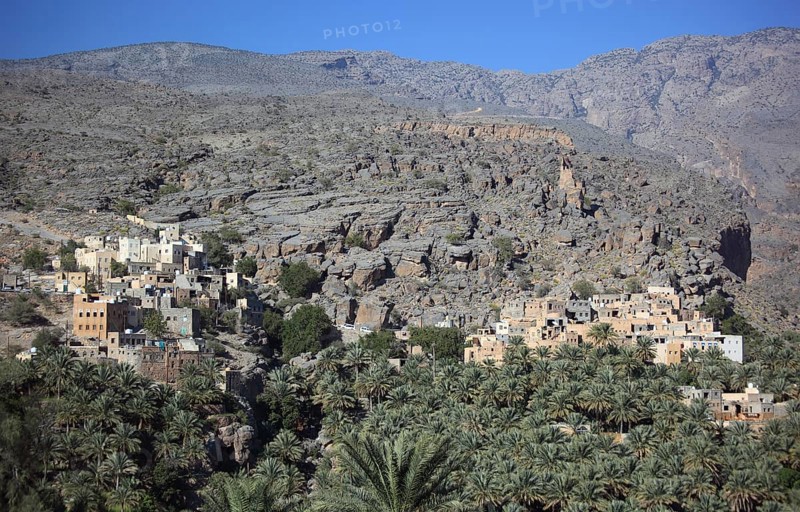Al-Hamra is one of the many interesting oases with an old mud part with red houses on stone foundations. Here is the district of Misfah, which lies on a steep hillside, Oman, Asia