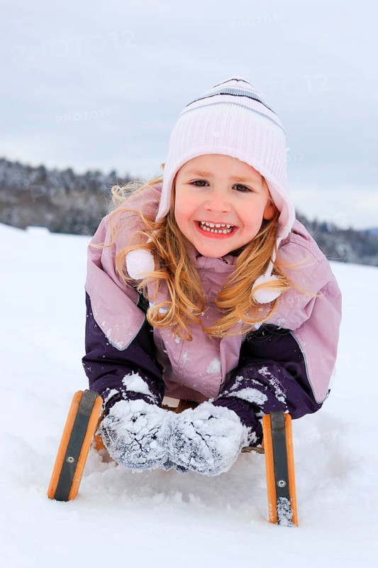 Girl on sleigh, Switzerland, Europe