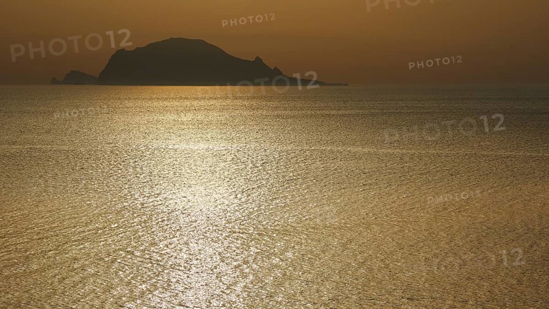 Santa Marina Salina, sunrise, sun rises behind Panarea, Panarea island near, light reflections on the sea, Salina, Aeolian Islands, Sicily, Italy, Europe
