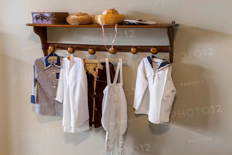 Old wardrobe with textiles and antique clothing
