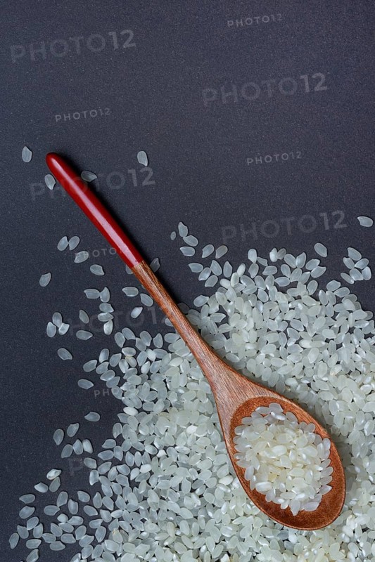 Rice, white rice grains in wooden spoon