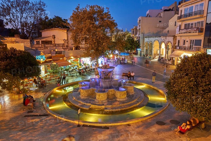 Night shot, blue evening sky, artificial lighting, Venetian Morosini Fountain, super wide angle, passers-by, downtown, old town, Heraklion, capital, island of Crete, Greece, Europe